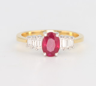 A yellow gold ruby and diamond ring, the oval cut ruby approx. 0.7ct flanked by 3 baguette diamonds to each shoulder, size M 