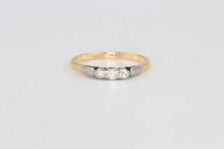 An 18ct yellow gold 3 stone diamond ring 2.4 grams, size R 1/2