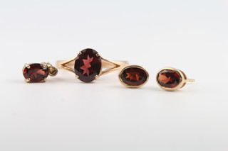 A 9ct yellow gold garnet set ring, pendant and earrings, the ring size M 