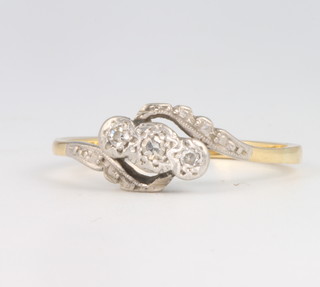 An 18ct yellow gold 3 stone diamond crossover ring, size  N, gross weight 2.6 grams