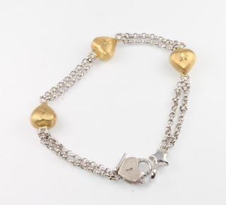 An 18ct 2 colour gold heart bracelet 9.1 grams