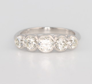 A platinum 5 stone diamond ring in a rub over setting approx. 1.4ct, size M 1/2