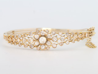 An 18ct yellow gold diamond set floral bracelet