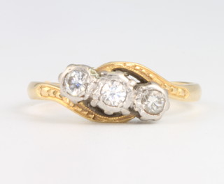 An 18ct yellow gold triple diamond crossover ring size N, gross weight 2.7grams