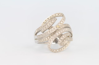 An 18ct white gold diamond set scroll ring size U 