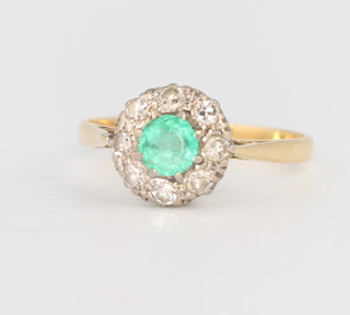 An 18ct yellow gold diamond and emerald cluster ring size P , gross weight 2.7grams