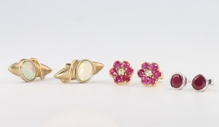 A pair of 9ct ruby and diamond ear studs, a pair of 18ct ruby ear studs and a pair of opal ear studs 