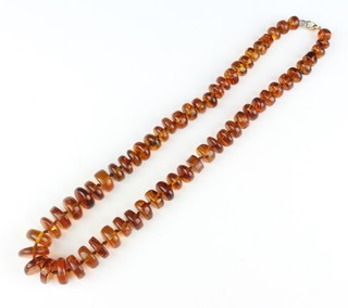 A string of orange amber beads, 52cm 