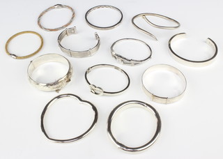 A silver christening bangle and a quantity of others, 250 grams 
