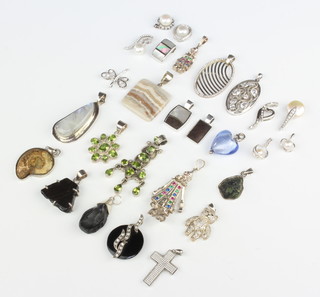 A collection of silver mounted pendants 