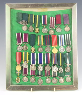 Thirty two miniature medals including Army Long Service and Good Conduct, Army Meritorious Service, Volunteer Officers Decoration etc, framed 
