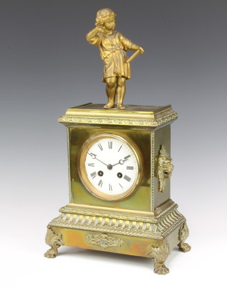 A 19th Century Continental 8 day striking mantel clock with enamelled dial and Roman numerals contained in a metal case supported by a figure of a scholarly girl, complete with pendulum and key  