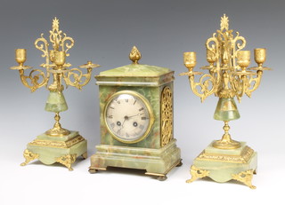A 19th Century French 8 day striking mantel clock, the silvered dial with Roman numerals contained in an onyx and gilt metal mounted case, the back plate marked 1973 4 8 13 (no pendulum or key) together with a pair of 4 light onyx and gilt metal candelabrum (missing a sconce and drip trays) 
