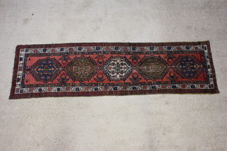 A Persian pink ground Sarab runner with 5 stylised diamonds to the centre within a multi row border 324cm x 90cm 