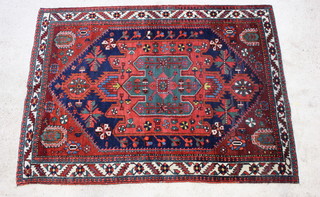A Persian red and blue ground Bakhtiari rug with central medallion 215cm x 149cm 
