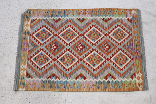 A multicoloured Choli Kilim rug with diamond design to the centre 148cm x 103cm 
