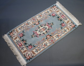 A turquoise ground and floral patterned Chinese rug 165cm x 93cm 