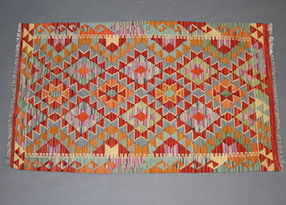 A gold, orange and green Kilim rug 138cm x 84cm  