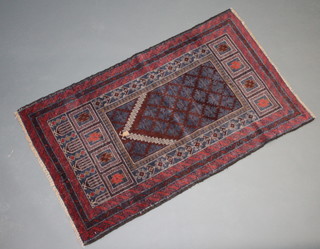 A brown and red ground Belouche prayer rug 140cm x 85cm 