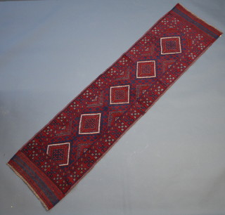 A red and blue ground Meshwani runner with 5 stylised diamonds to the centre within a multi row border 255cm x 62cm 