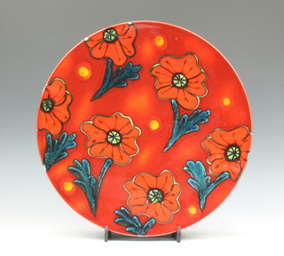 A Poole Pottery red ground charger decorated with poppies 14.5cm 