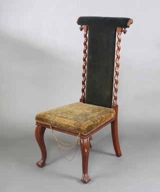 A Victorian rosewood prie dieu chair with spiral turned columns to the side, having an upholstered seat and back and raised on cabriole supports 