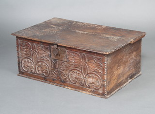 A 17th/18th Century carved oak bible box with hinged lid, the front marked MS 30cm h x 72cm w x 47cm d 