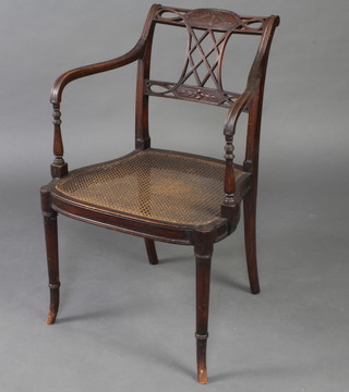 A Regency style mahogany bar back open arm chair, raised on turned supports 
