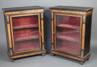 A pair of Victorian ebonised pier cabinets, fitted shelves enclosed by panelled doors and with gilt metal mounts 109cm h x 82cm w x 35cm d 
