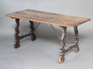A rectangular Spanish oak trestle table with planked top, raised on pierced supports 70cm h x 157cm l x 69cm w
