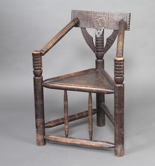 A carved oak turners chair with turned stretcher 