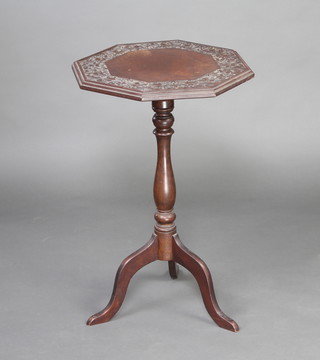 An octagonal carved oak and walnut wine table, raised on pillar and tripod supports 74cm h x 50cm w x 50cm d 