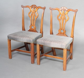 A pair of Chippendale style mahogany slat back dining chairs with over stuffed seats raised on square tapered supports with H framed stretcher 