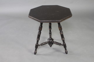 A Victorian octagonal ebonised cricket table raised on turned and fluted supports with X framed stretcher, there is a paper label to the underside marked From Druce and Company, Portman square 61cm x 56cm x 56cm 