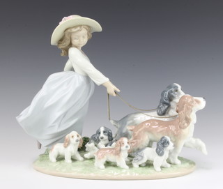 A Lladro figure of a young lady holding 2 spaniels on leads with 5 puppies no.6784 22cm, boxed 