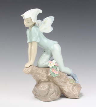 A Lladro Privilege figure of a nymph kneeling on a trunk no.7690 22cm, boxed