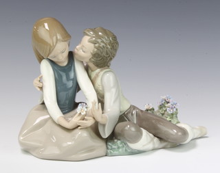 A Lladro group of a courting couple the lady holding flowers 14cm, boxed 