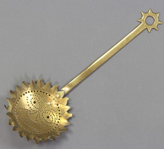 An 18th/19th Century pierced brass cream skimmer decorated a sun 

