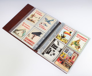 An album containing 114 Guinness postcards 