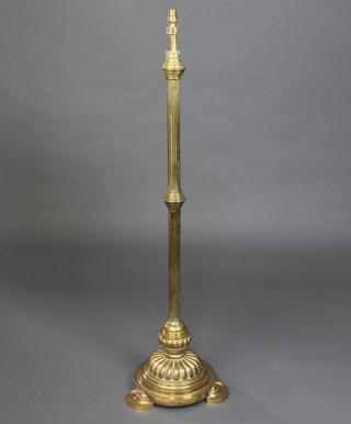 A 19th Century adjustable reeded brass oil lamp stand converted to electricity, raised on a circular foot 
