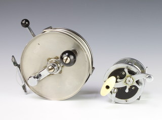 A steel Big Game centre pin fishing reel 6cm and 1 other centre pin reel 
 
