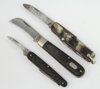 J M Thompson of Sheffield, a twin bladed folding knife with horn effect grip, a three bladed French folding knife with corkscrew spike and horn grip, together with a folding a knife the blade marked Stainless Inox the grip marked WIlkinson Sword  