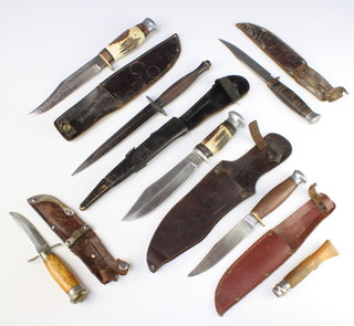 A Fairbairn Sykes style fighting knife with leather scabbard, a William Rodgers Bowie knife with horn grip and leather scabbard and 1 other, 2 other Bowie knives with leather scabbards, a Swedish skinning knife with wooden grip and a French folding knife  