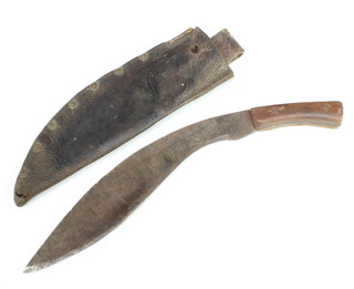 A Kukri with wooden grip and 32cm blade contained in a leather scabbard marked CA 1917 with broad arrow mark 