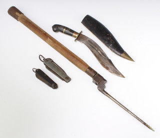 A military style folding knife with blade and marlin spike, a similar knife with blade and tin opener, a pig stick bayonet (no scabbard),an Eastern dagger  with etched bladed contained in a leather scabbard  and a pick axe handle shaft 
