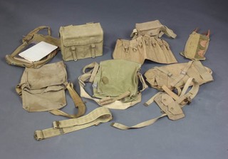 A pair of British webbing gaiters dated 1944, a webbing gas mask bag dated 1942 (metal disc to side missing), a webbing binocular case dated 1940, do. gas mask bag dated 1943 and other British webbing  