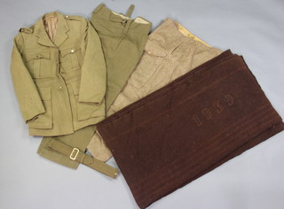 A brown military blanket marked HM (some moth), a Miller, Rayner & Haysom service dress tunic dated 18 3 1940 no insignia and staybrite buttons (some moth), a pair of service dress trousers (some moth and belt), a pair of battle dress trousers dated 1947 