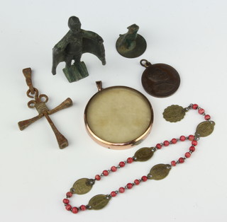A bronze figure of a standing gentleman 8cm, a bronze seal in the form of a goose 4cm, an iron cross 8cm formed from "nails", a Pious 10th bronze papal medal, a circular gilt metal miniature mount 5cm and a rosary 