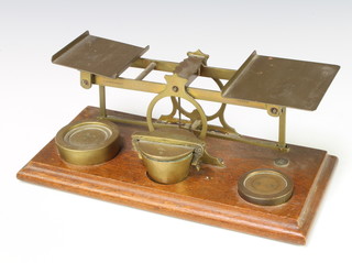 S Mordan & Co, a set of brass letter scales raised on a mahogany stand and 2 associated brass weights - 16ozs and 8ozs, together with an associated set of 8 Continental  bucket weights - 100g, 50g, 50g, 20g, 10g, 10g, 5g and 500