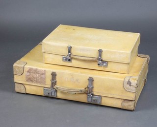 A Revelation parchment suitcase with chrome mounts 19cm x 71cm x 40cm with a Southern Railways luggage label, 1 other suitcase 13cm x 51cm x 30cm 
